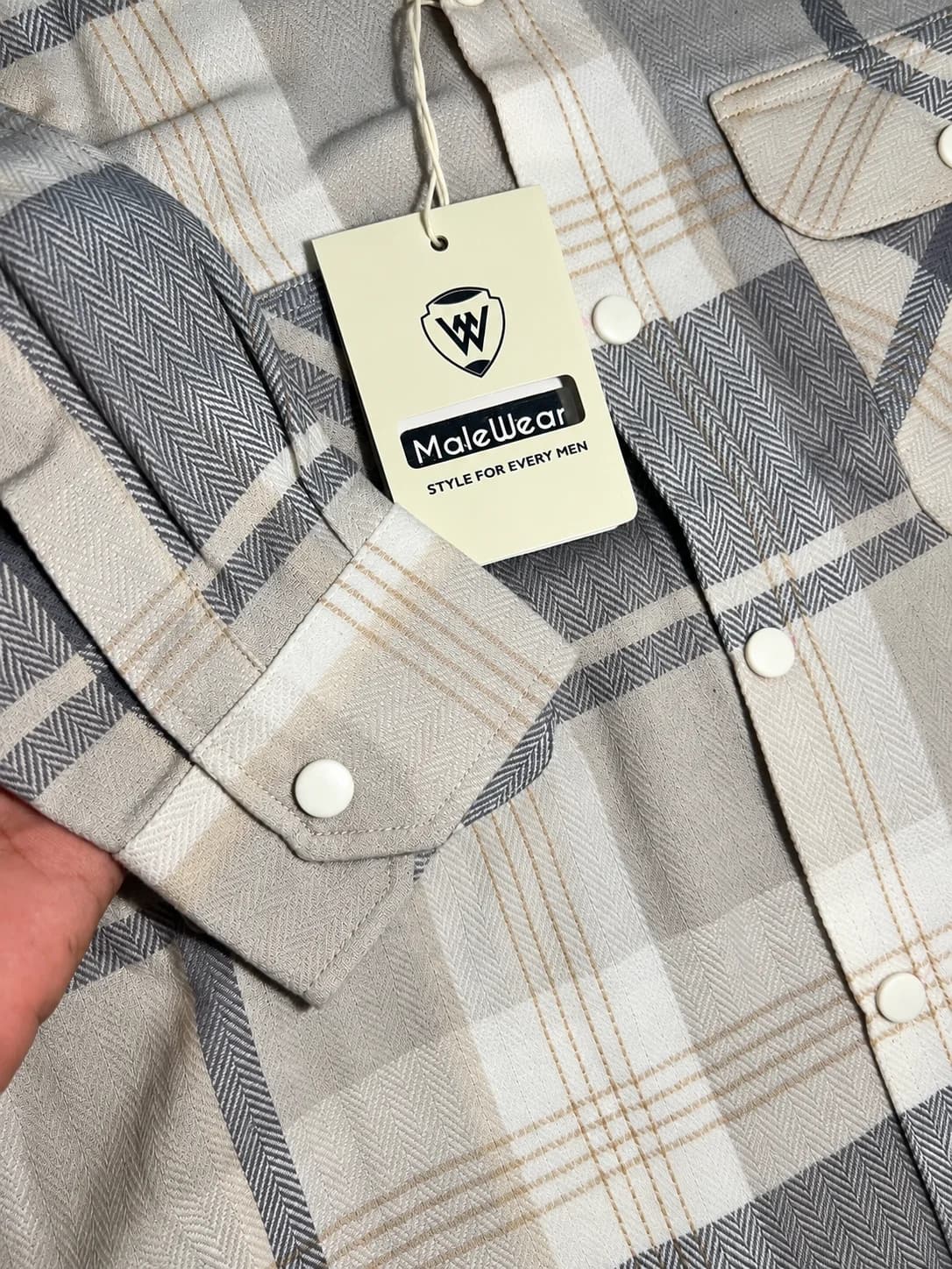 MaleWear Men's Grey and Cream Checkered Long Sleeve Shirt Close-Up with Adjustable Buttoned Cuff, Plaid Fabric Design and MaleWear Brand Hang Tag