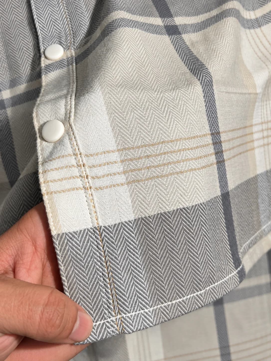 MaleWear Men's Grey and Cream Checkered Long Sleeve Shirt Close-Up with Adjustable Buttoned Cuff, Plaid Fabric Design and MaleWear Brand Hang Tag