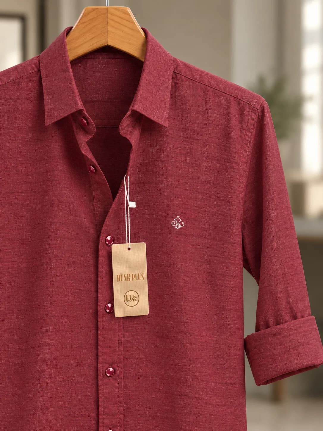 Close-up of the HUNK PLUS maroon shirt collar, inner brand label and hanging tag.