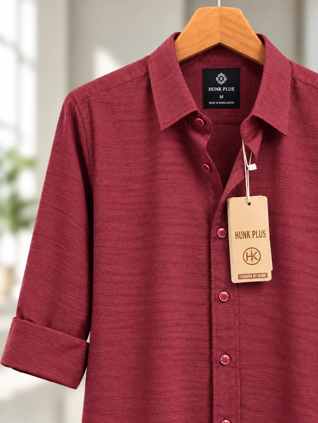 Maroon long sleeve shirt showing the plain pointed collar, matching buttons and rolled sleeve.