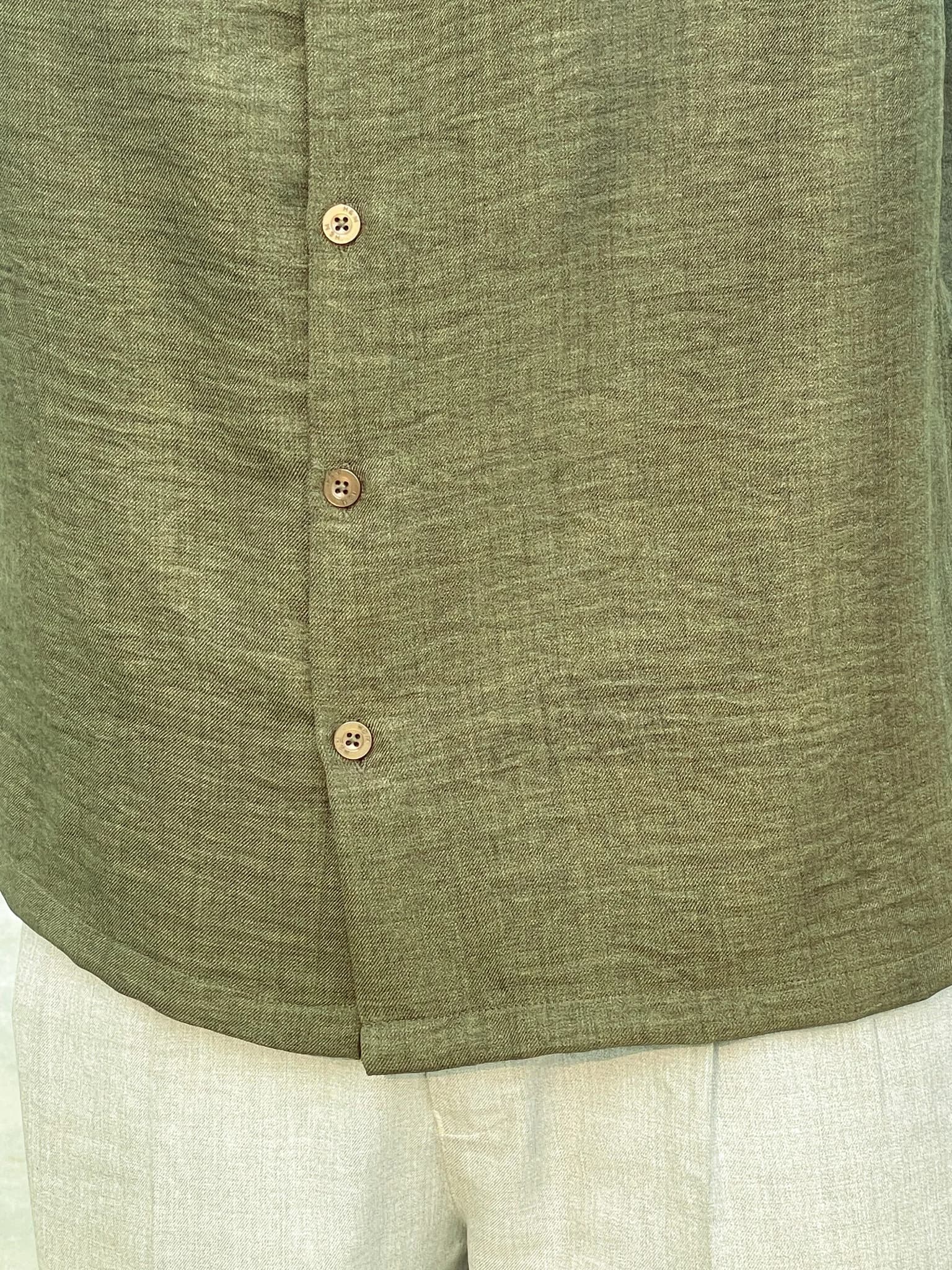 Close-up of the olive shirt’s classic collar and front buttons